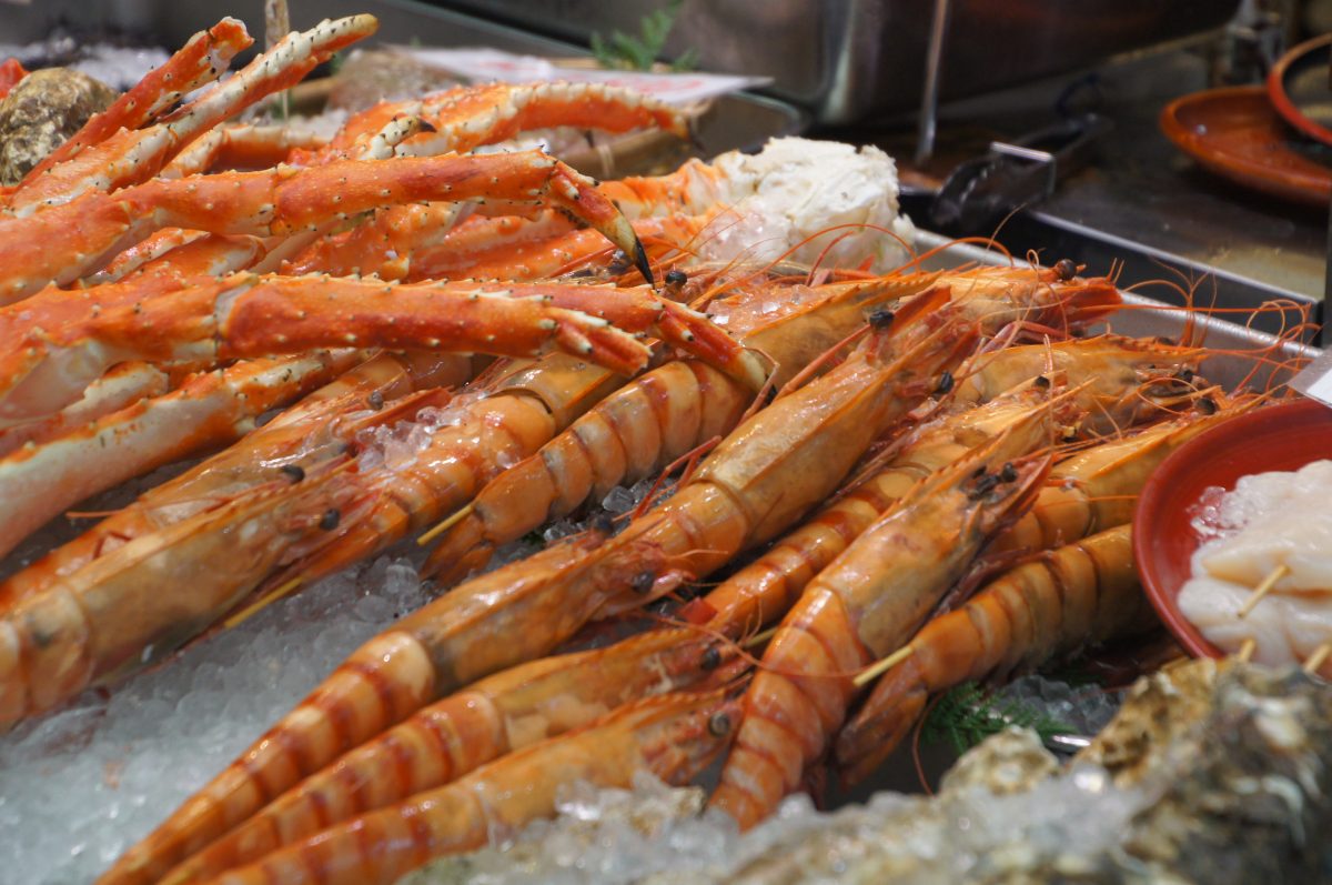 Rows of crab legs displayed on ice at Kuromon Market