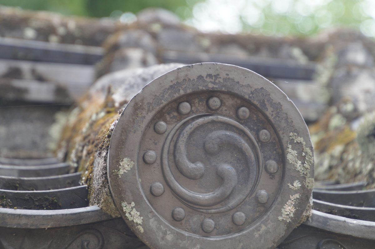 Crest-stamped roof tiles on a wall at Himeji Castle