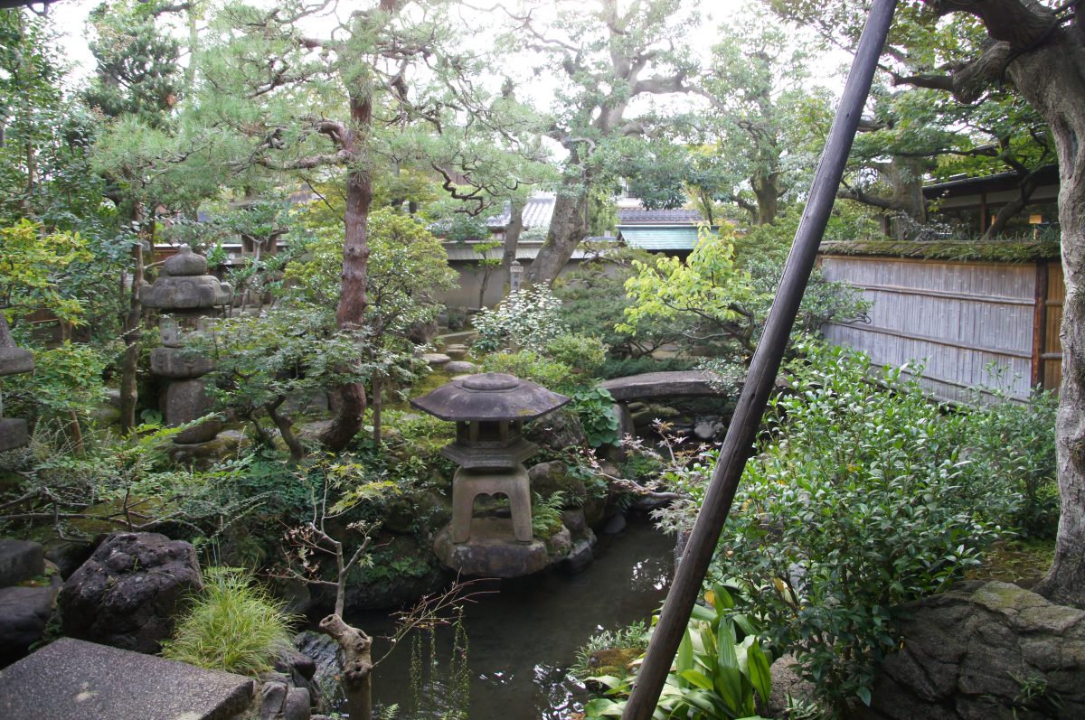 Tatami room with decorated sliding doors and a Buddhist altar at Nomura Samurai Residence