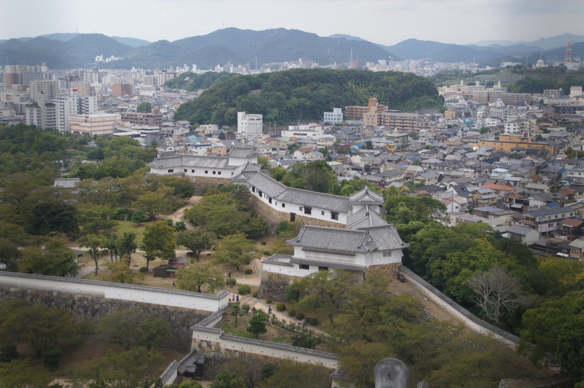 View over Himeji city and castle roofs from the top of Himeji Castle keep on a rainy day