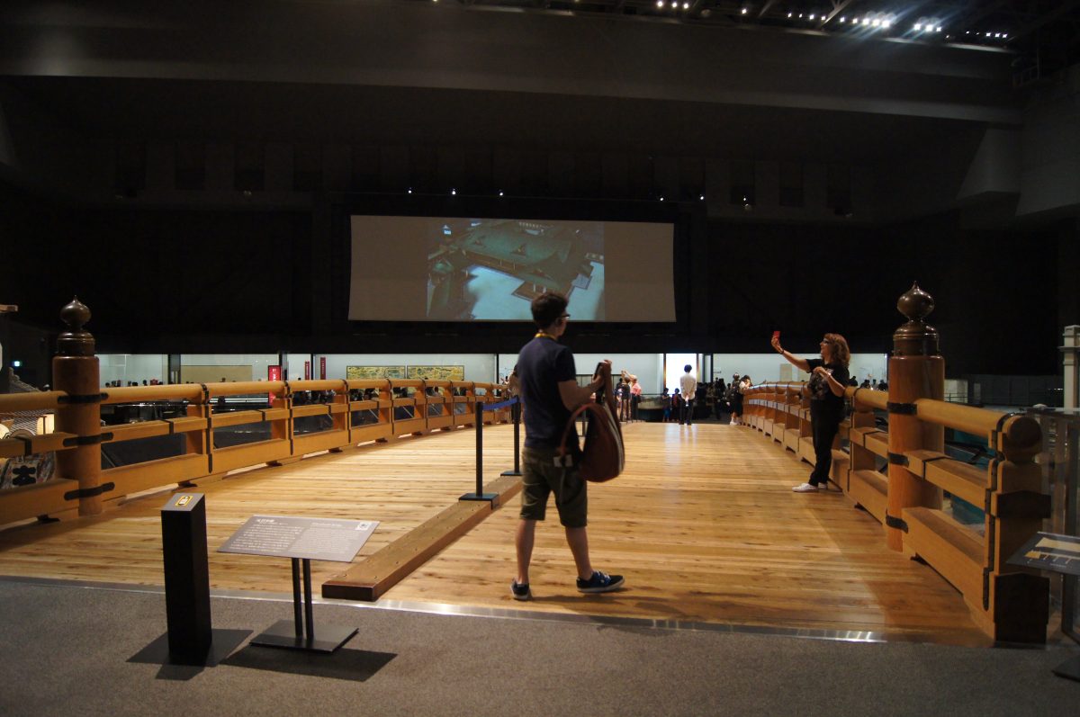 Edo Tokyo Museum 4 A visitor crosses a wooden bridge inside a gallery at the Edo-Tokyo Museum.