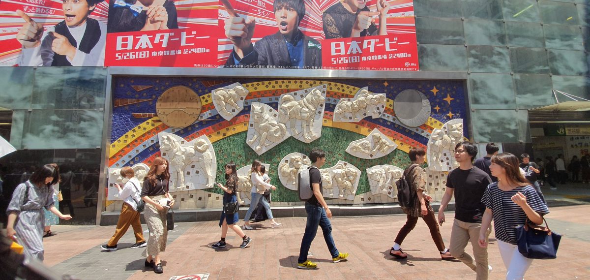 Hachiko Dog 22 The Hachiko mosaic mural in Shibuya with people walking past