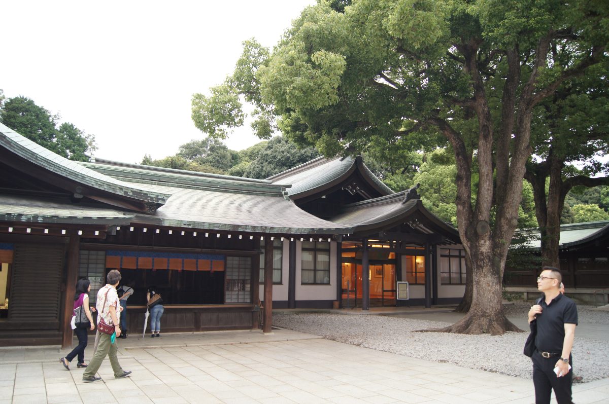 Green-roofed shrine buildings around the courtyard at Meiji Jingu.