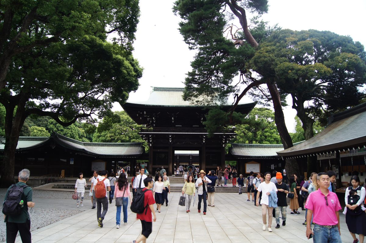 Visitors in the courtyard in front of the gate to the main shrine at Meiji Jingu.