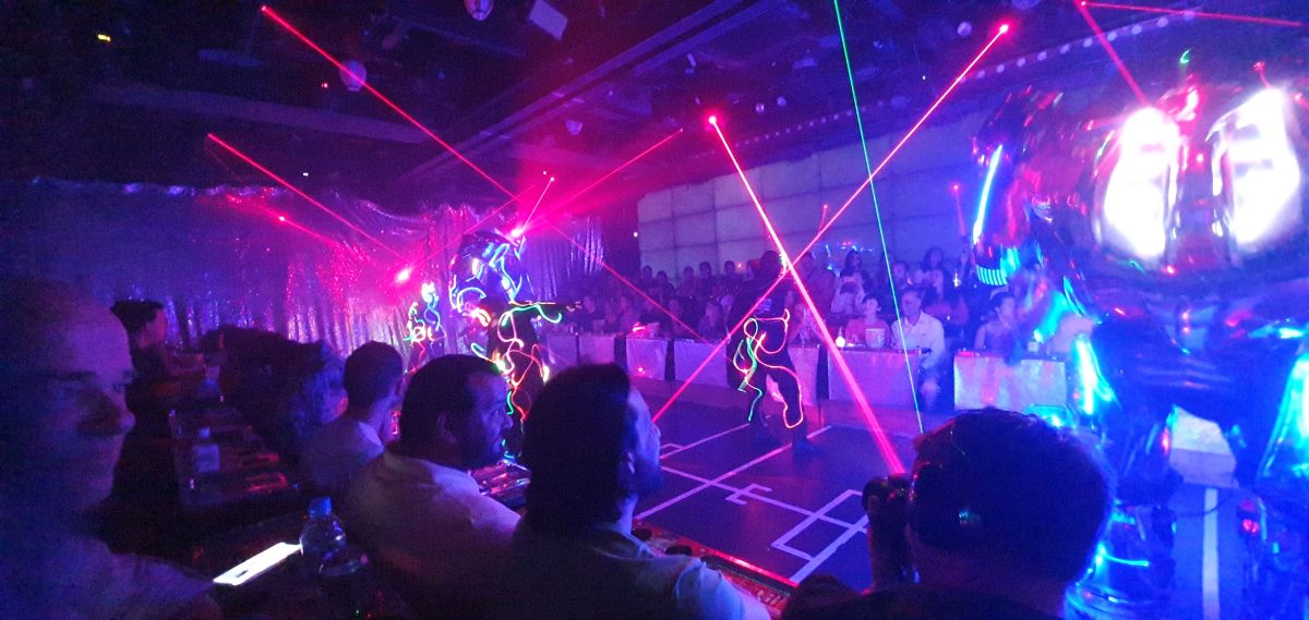 Robot Restaurant 259 An illuminated robot and performers in glowing suits among laser beams at the Robot Restaurant