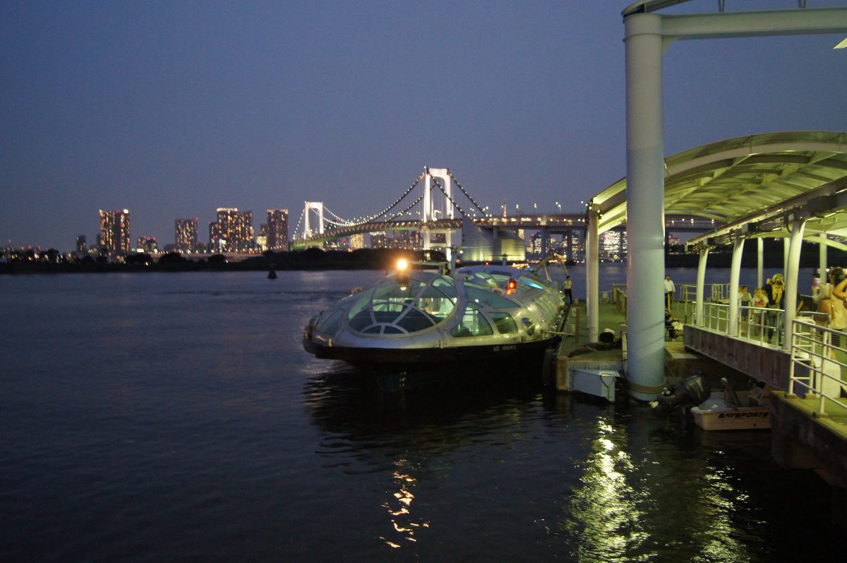 Tokyo Boat Cruise 7 A futuristic water bus moored at a pier in Odaiba at dusk