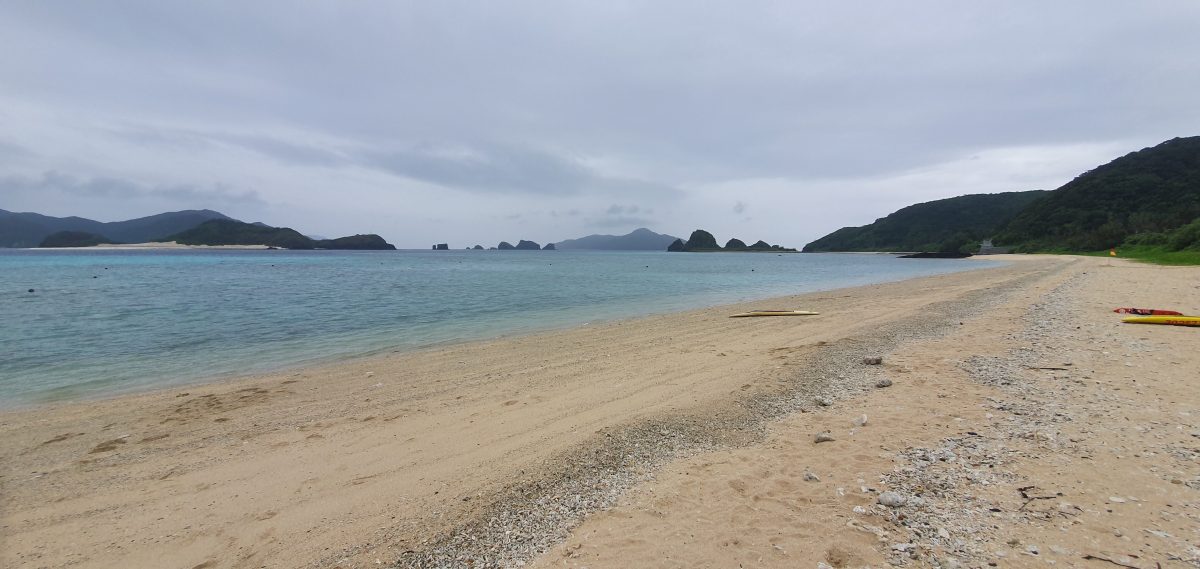 Zamami 19 Empty sandy beach and calm sea beneath an overcast sky on Zamami Island