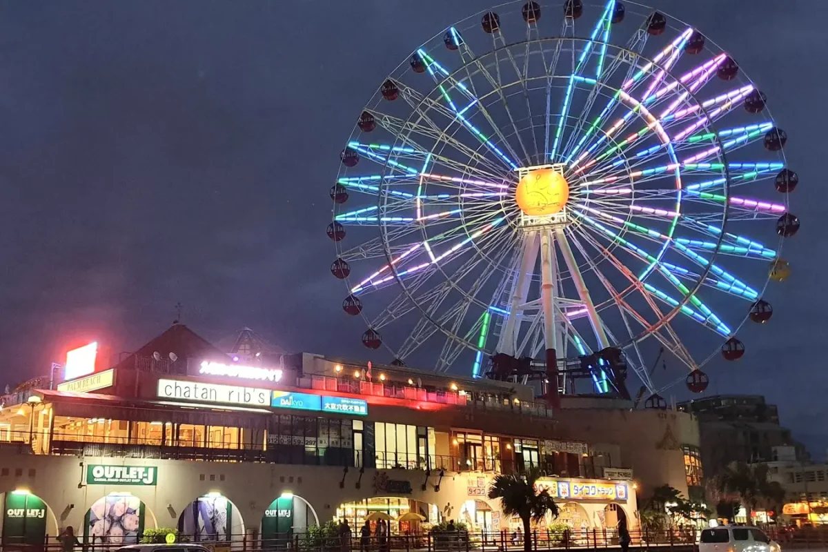Illuminated Ferris wheel and restaurant buildings at American Village during our May 2019 visit