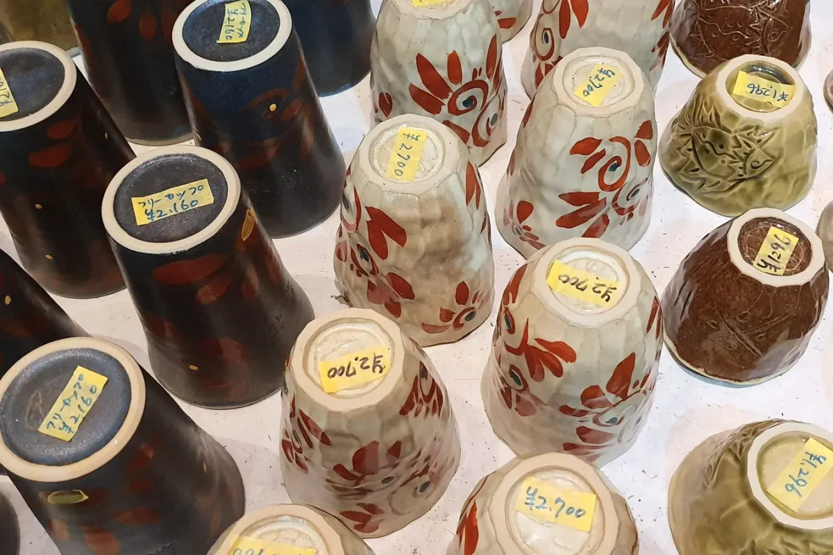 Decorated ceramic cups and bowls displayed at Ryukyu Mura