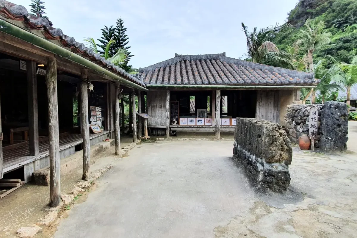 Stone courtyard surrounded by traditional buildings at Ryukyu Mura