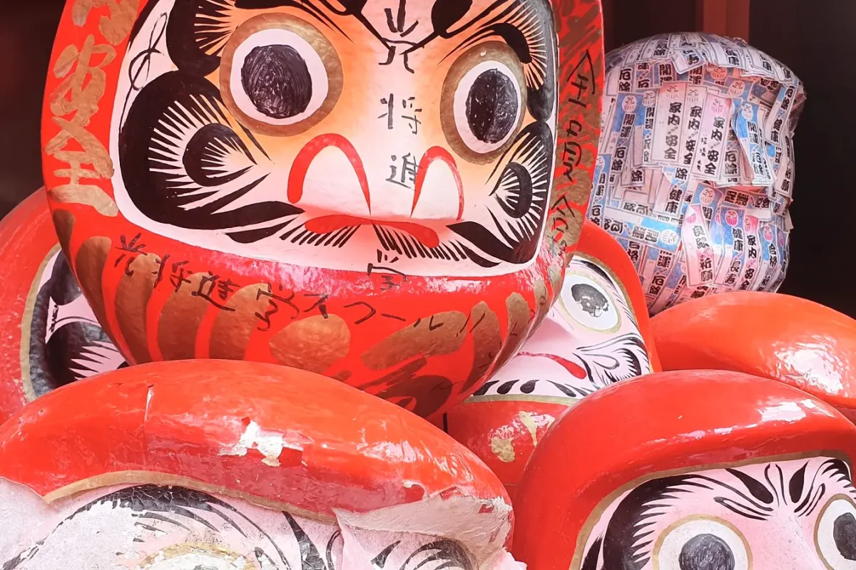 Daruma figures displayed at the temple in Shuri