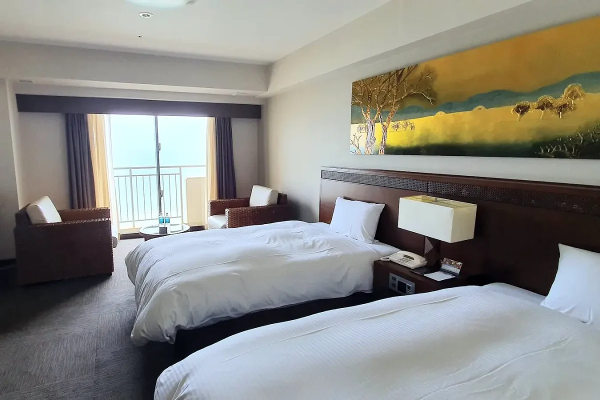 Twin guest room with seating area at Grandvrio Resort Ishigakijima