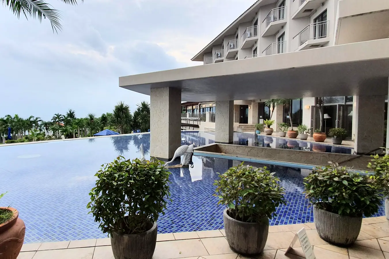 Grandvrio Resort Ishigakijima building and decorative blue-tiled water feature beside the sea