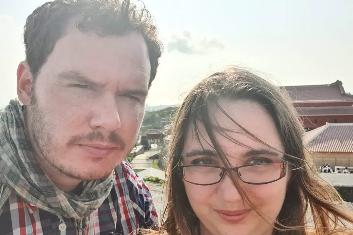 Kat and Gary taking a selfie at Shuri Castle during their May 2019 honeymoon