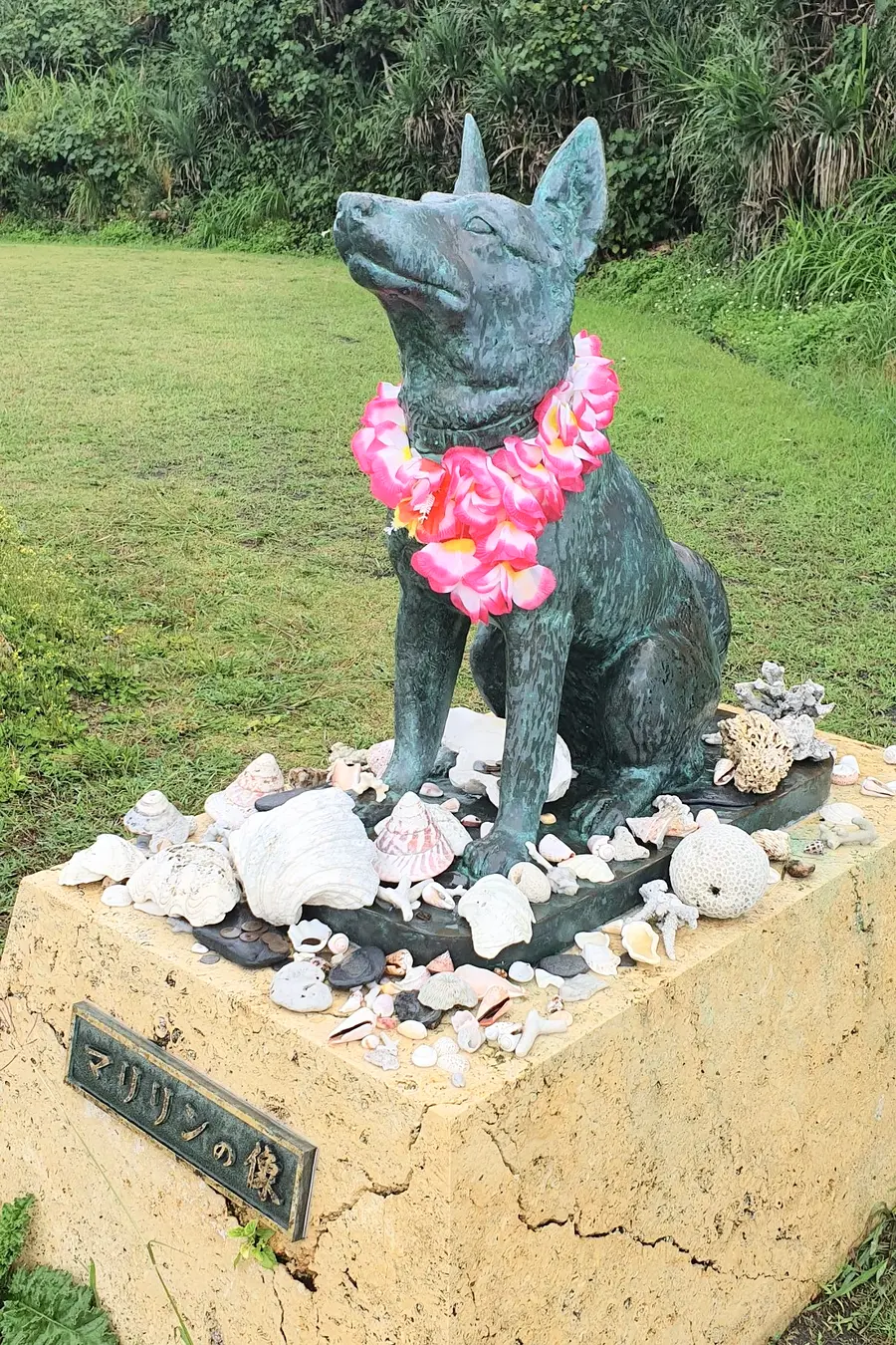 Marilyn dog statue decorated with flowers and shells on Zamami