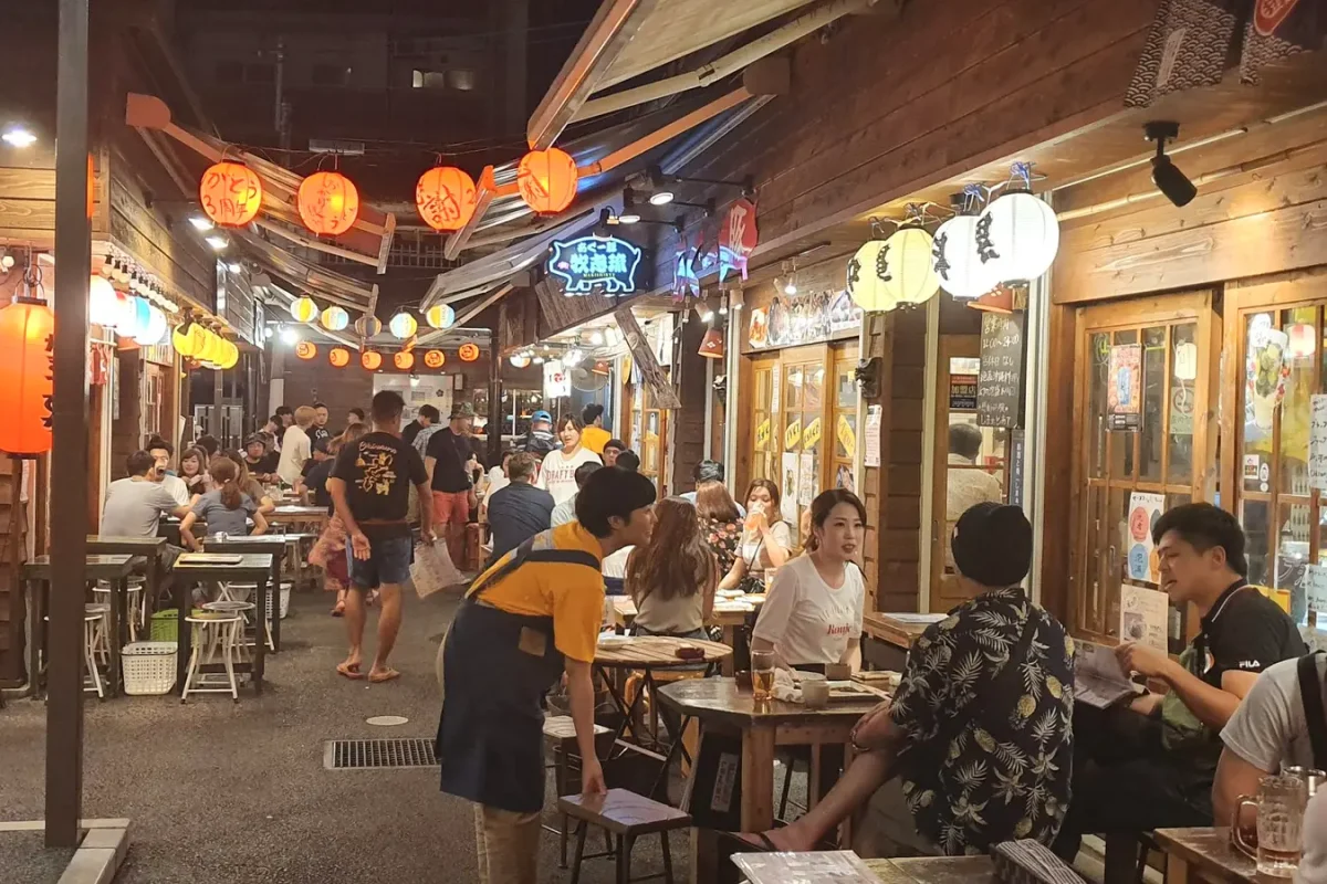 okinawa naha food village at night 11346 Diners and lantern-lit restaurant fronts at Naha food village