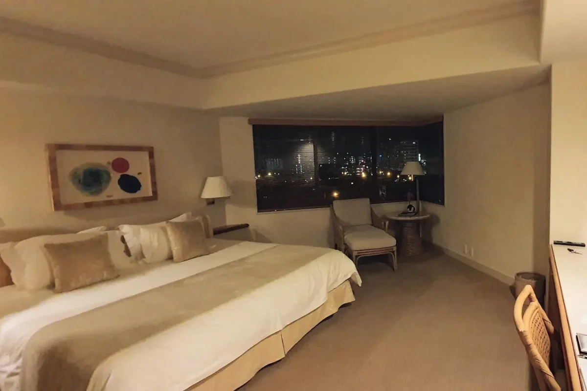 Spacious guest room at The Naha Terrace with a large bed and city view