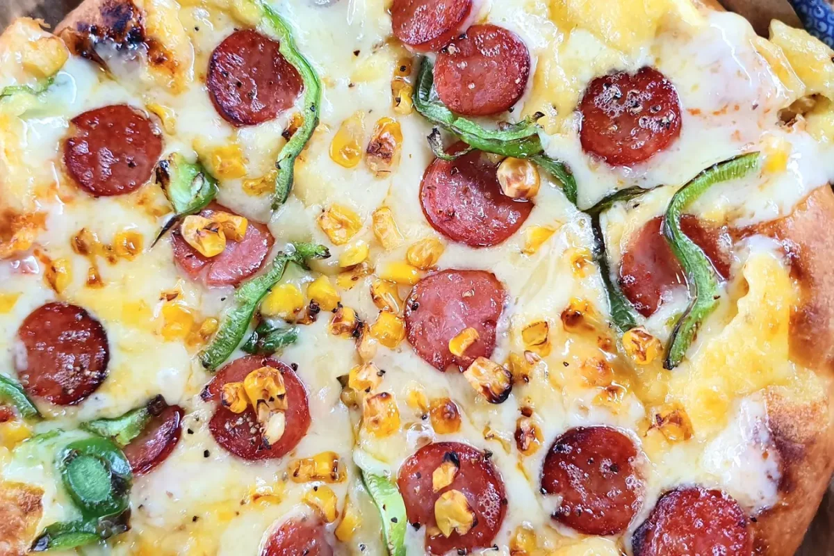 Pizza topped with cheese, pepperoni, peppers and sweetcorn at Pizza in the Sky