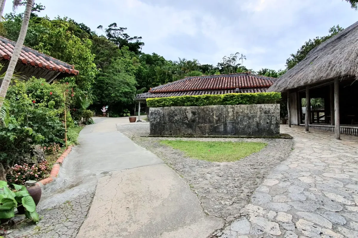 Stone paved village lane between traditional buildings at Ryukyu Mura