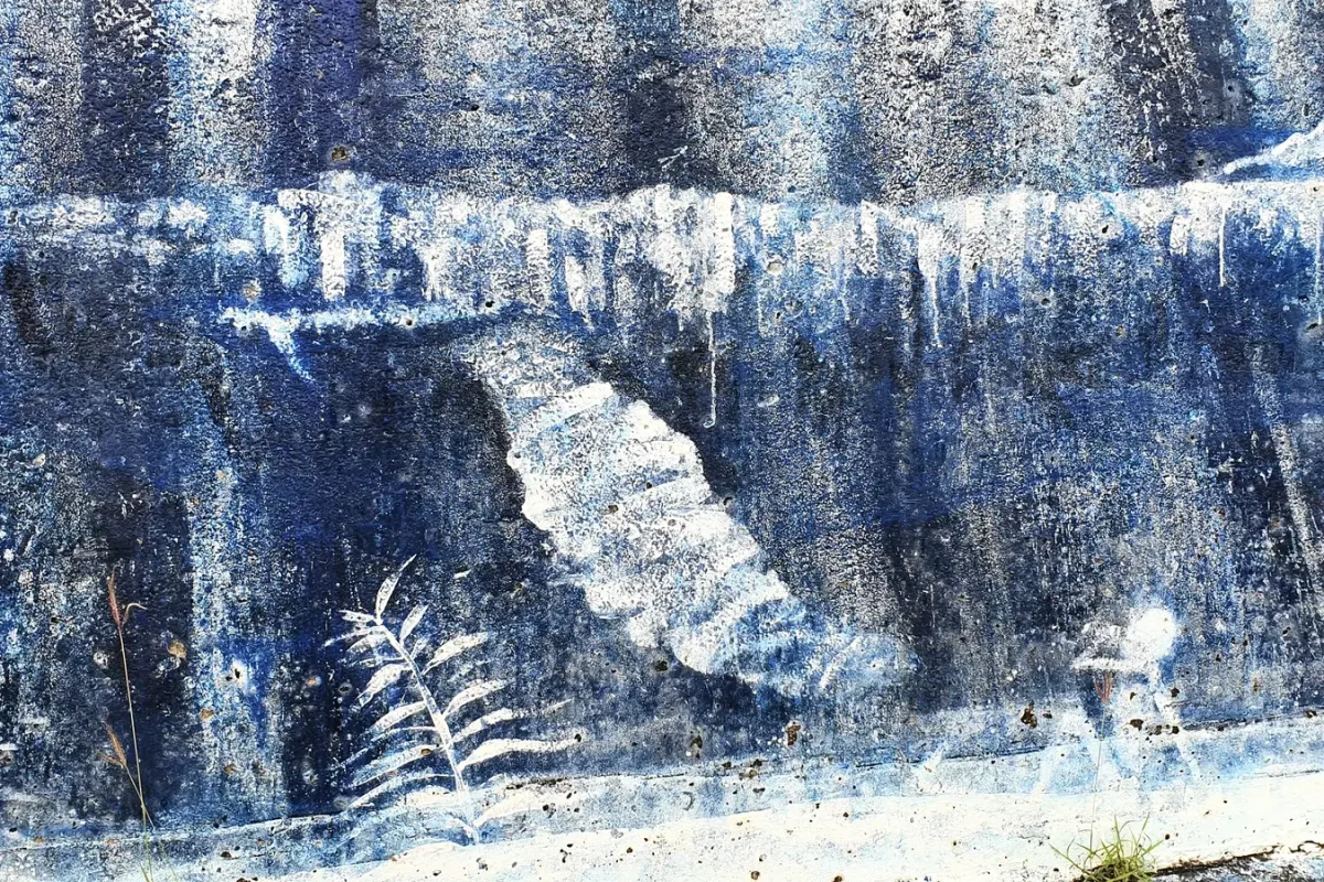 Weathered blue and white whale mural on a wall on Zamami