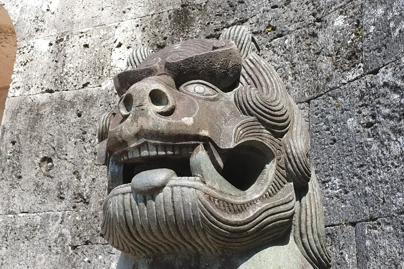 Stone guardian beside a gate at Shuri Castle in May 2019