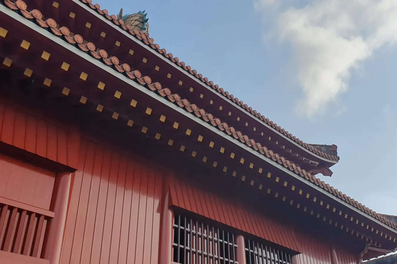 Painted eaves and red walls at Shuri Castle in May 2019