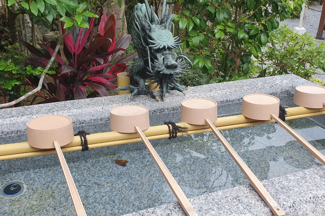 Water basin and wooden ladles at Sairaiin temple in Shuri