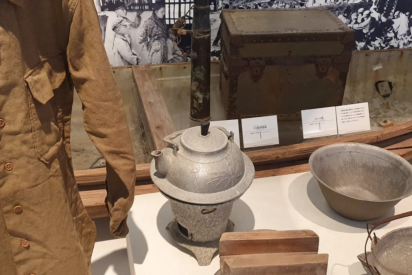 uf e9a1d7b14b1d4eb7 Uniform, kettle, bowls and other objects in a history display at Okinawa Prefectural Museum