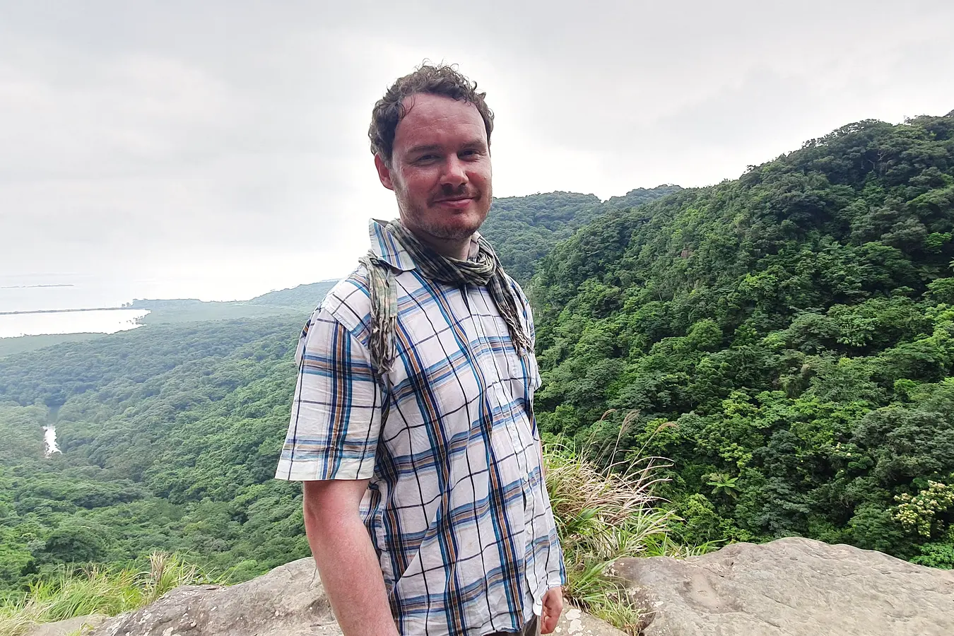 Gary at the viewpoint above Pinaisara Falls with Iriomote forest behind him